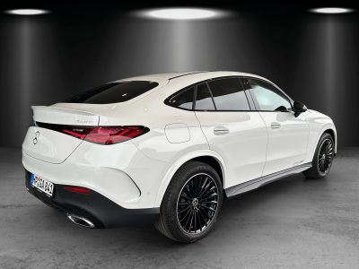 Heckansicht eines weißen Mercedes-Benz SUV-Coupés mit sportlichem Design, 4MATIC-Allradantrieb und schwarzen Leichtmetallfelgen – ausgeleuchtet im Studio-Setup.